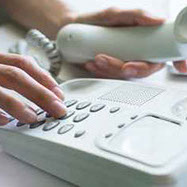 Female hand dialing phone